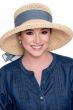 Woman in dressy brimmed structured summer sun hat with decorative ribbon