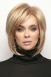 Woman in blonde short bob wig with longer layers in front and bangs