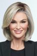Woman in a chin length light blonde lace front bob wig with long side bangs