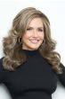 Woman in an extra long dark brown curly lace front wig with feathered layers