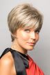 Woman in a long layered light blonde pixie wig with fringe bangs