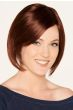 Woman in a chin length medium auburn bob wig with side bangs