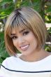 Woman in a chin length light blonde blunt bob wig with textured bangs