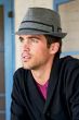 Man outdoors in narrow brimmed winter tweed fedora hat for men