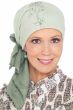 Woman in green tie dyed head scarf with sequins for women with cancer