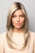 Woman in long blonde wig with straight hair and dark roots with slight layers