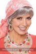 Woman in a short wavy grey halo wig with bangs under a head scarf