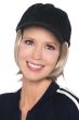 Woman in black baseball cap with straight short blonde synthetic hair attached