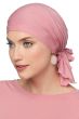 Woman in pink pre tied head scarf for cancer patients