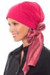 Woman in pink head covering with long printed bow
