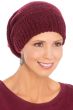 Woman in cute red knitted winter beanie hat with sequins