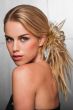 Woman in a scrunchie with spiky blonde hair attached to her ponytail