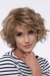 Woman in a chin length curly dark blonde layered bob wig