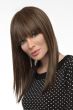 Woman in an extra long straight medium brown human hair wig with blunt bangs