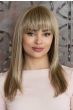 Woman in an extra long straight medium brown human hair wig with blunt bangs