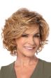Woman in a large past the chin light auburn curly layered bob wig