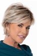 Woman in a light blonde long pixie wig with side bangs