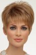 Woman in a classic blonde pixie wig with fringe bangs and longer layers on top