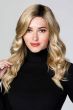 Woman in an 18" curly light blonde lace front hair topper for thinning hair