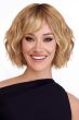 Woman in a chin length wavy ash blonde lace front wig with choppy bangs