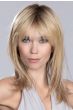 Woman in a past the shoulders medium blonde straight layered wig with fringe bangs