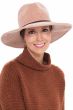 Woman in wide brimmed beige chenille fedora hat with wide headband underneath for cancer patients