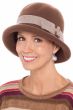 Woman in brown wool winter cloche hat with upturned brim and tortoiseshell buckle