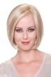 Woman in a chin length slightly angled light blonde bob wig