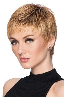 Woman in a reddish blonde textured pixie wig with short bangs