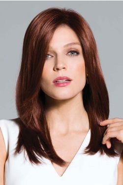 Woman in long straight dirty blonde wig with bangs and layers
