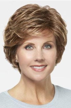 Woman in a short evenly layered red blonde bob wig with side bangs