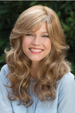 Woman in long curly blonde wig with bangs