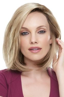 Woman in a shoulder length blonde blunt bob wig with long layers