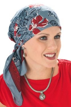 Woman in denim blue floral hand stamped head scarf for cancer patients