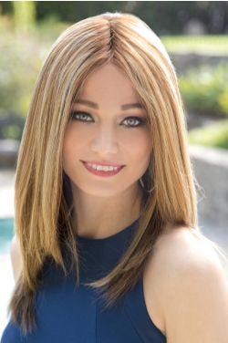 Woman in a past the shoulder light blonde straight wig with long layers