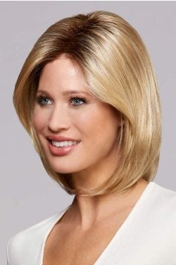 Woman in a shoulder length gold blonde bob wig with dark roots