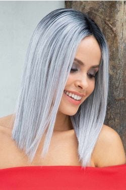 Woman in a straight past the shoulders silver blunt cut wig