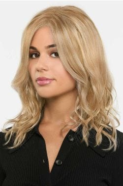 Woman in a past the shoulders warm blonde curly lace front wig