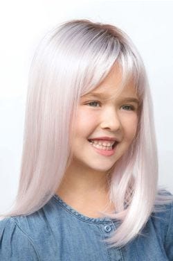 Young girl in a long children's wig in pastel pink with darker roots and wispy bangs