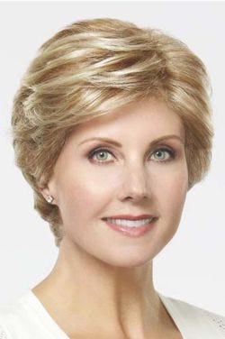 Woman in a short warm blonde wig with longer layers on top