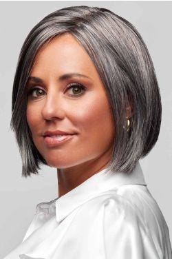 Woman in a chin length salt and pepper lace front bob wig