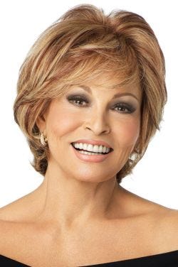 Raquel Welch in a light auburn heavily layered cropped bob wig with choppy bangs