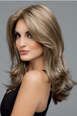 Woman in an extra long ash blonde wig with face framing and shoulder length layers