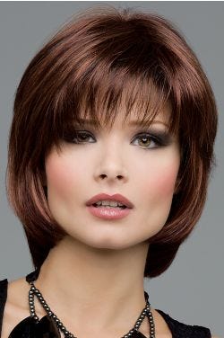 Woman in a short medium auburn bob wig with shaggy bangs and short face framing layers
