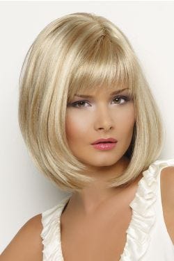 Woman in a shoulder length light blonde bob wig with face framing layers and feathered bangs