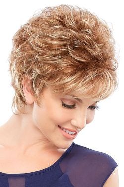 Woman in a petite curly auburn highlighted pixie wig with side swept bangs