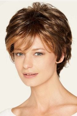 Woman in a medium auburn short wig with longer layers on the top and sides plus fringe bangs