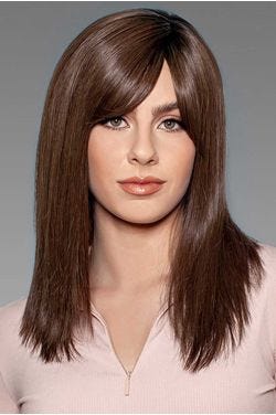 Woman in a large past the shoulders dark brown human hair wig with side bangs