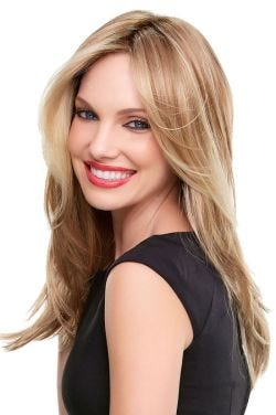 Woman in an extra long medium blonde layered wig with face framing layers