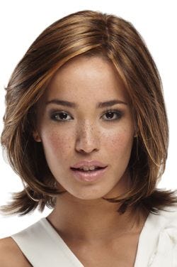 Woman in petite shoulder length, layered, brunette lace front wig with blonde and red highlights